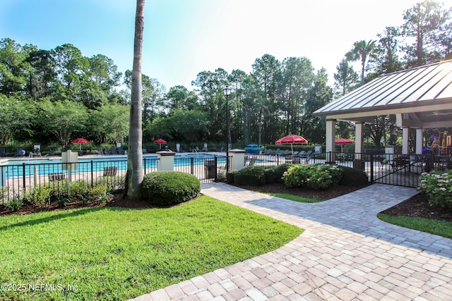 pool with a patio area, a gazebo, fence, and a yard