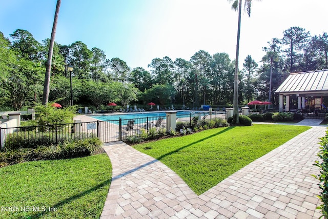 pool with a yard and fence