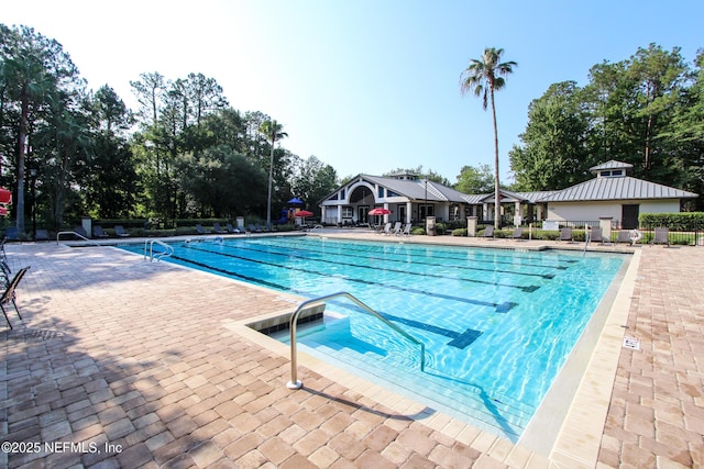 pool with fence and a patio