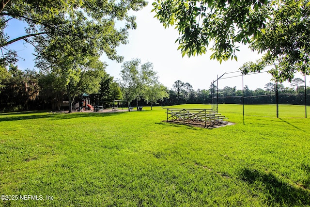 view of property's community featuring a lawn and playground community