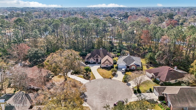 birds eye view of property featuring a residential view and a wooded view