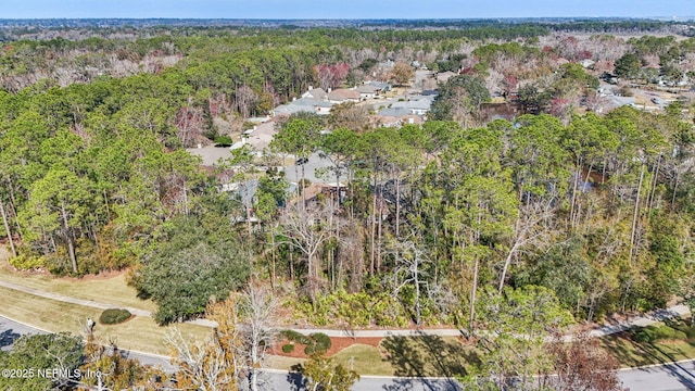 aerial view featuring a wooded view