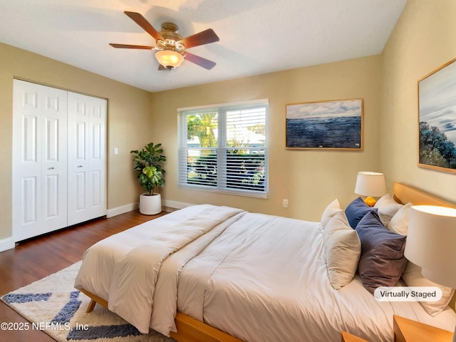 bedroom with ceiling fan, dark hardwood / wood-style floors, and a closet