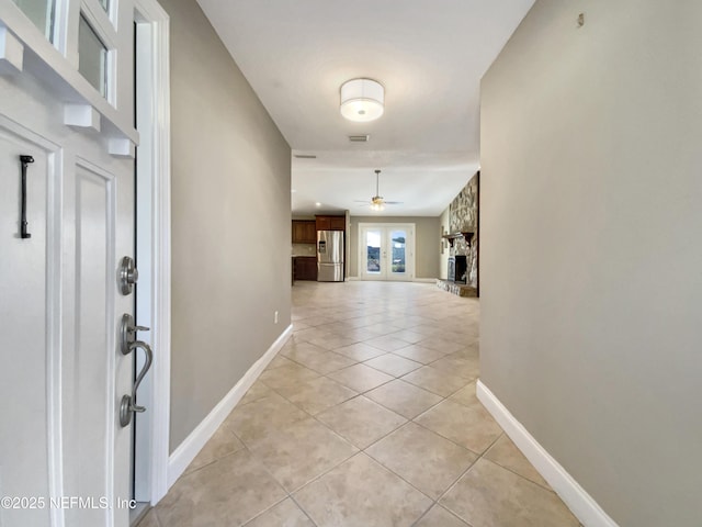 hall featuring light tile patterned floors