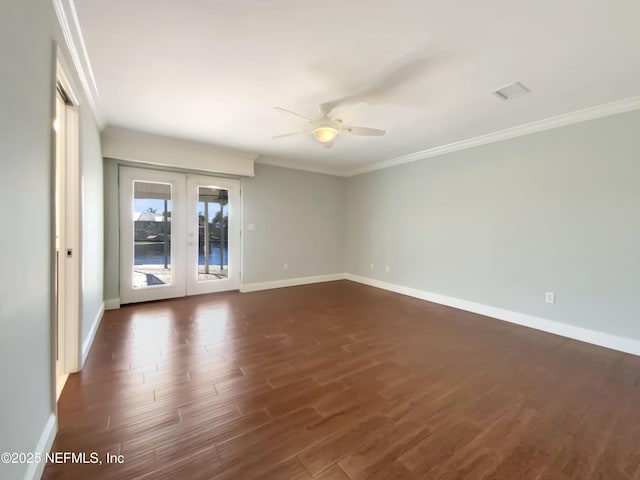 unfurnished room featuring crown molding, ceiling fan, dark wood-type flooring, and french doors