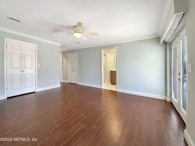 empty room featuring crown molding, dark wood-type flooring, and ceiling fan