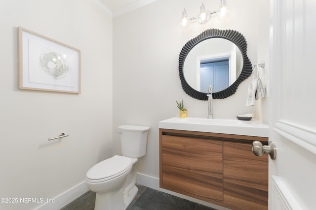 bathroom featuring vanity, crown molding, and toilet