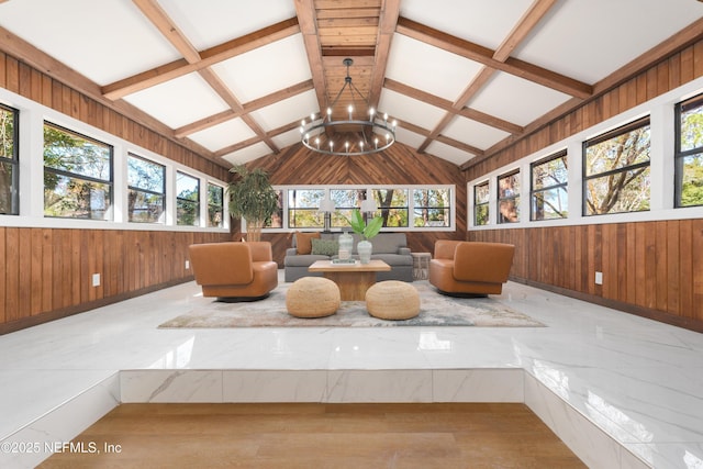 sunroom with a chandelier and lofted ceiling with beams