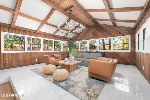 sunroom featuring lofted ceiling with beams and a chandelier