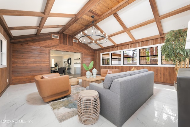 living room with lofted ceiling with beams, a notable chandelier, and wood walls