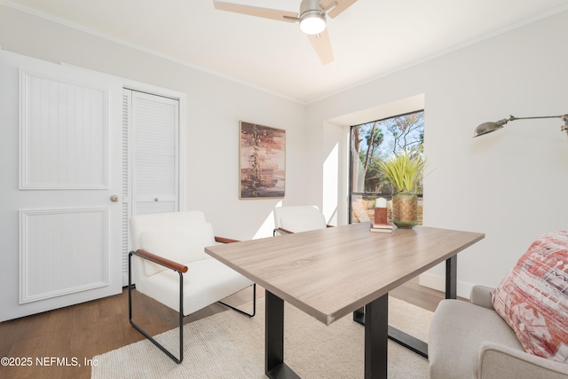 home office with crown molding, ceiling fan, and hardwood / wood-style floors