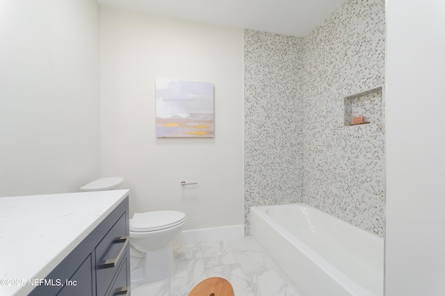 bathroom with vanity, toilet, and a tub