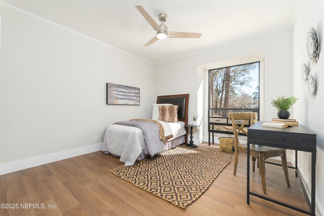 bedroom featuring hardwood / wood-style floors, ornamental molding, and ceiling fan