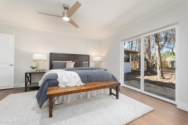 bedroom featuring crown molding, access to exterior, hardwood / wood-style flooring, and ceiling fan