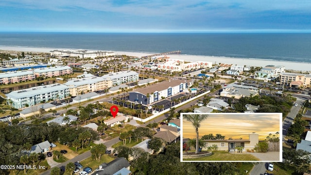 drone / aerial view with a water view and a view of the beach