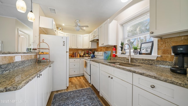 kitchen featuring sink, white cabinetry, hanging light fixtures, white appliances, and backsplash