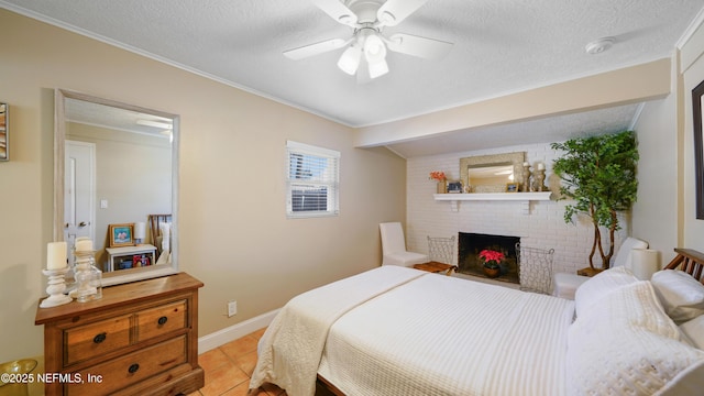 tiled bedroom featuring a brick fireplace, a textured ceiling, and ceiling fan