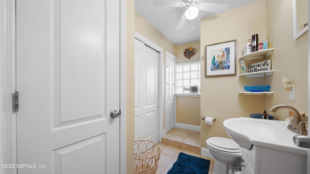 bathroom featuring tile patterned flooring, sink, toilet, and ceiling fan