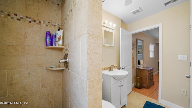 bathroom featuring tile patterned flooring, vanity, and ceiling fan