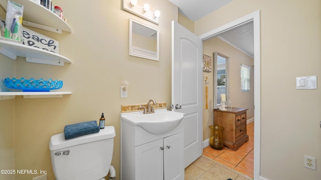 bathroom featuring vanity, tile patterned floors, and toilet