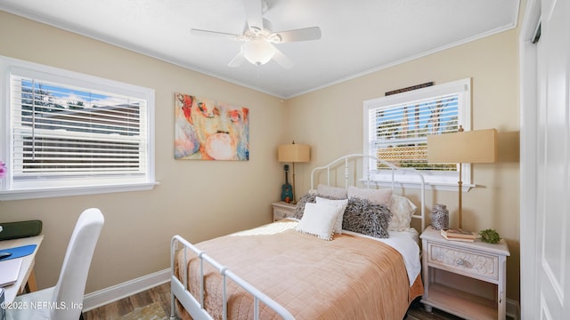 bedroom featuring crown molding, hardwood / wood-style flooring, and ceiling fan