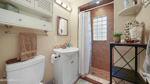 bathroom with vanity, toilet, and curtained shower