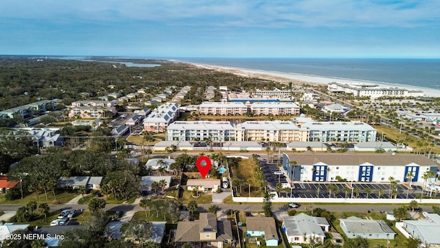 drone / aerial view featuring a water view and a view of the beach