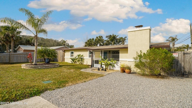 rear view of house with a yard