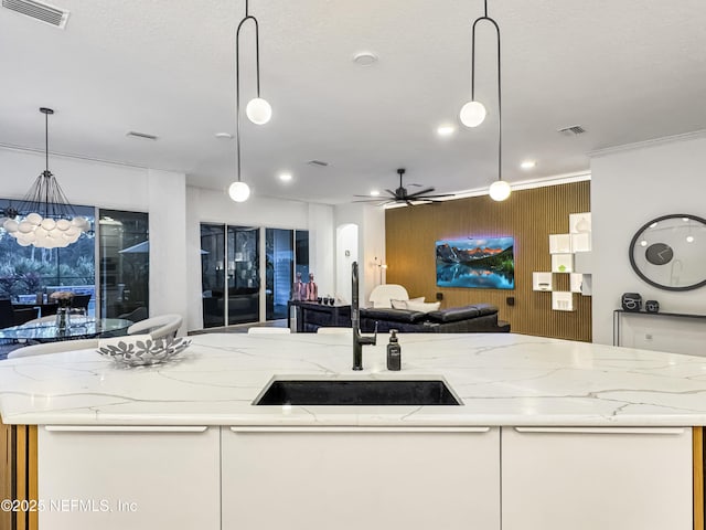 kitchen with pendant lighting and a center island with sink