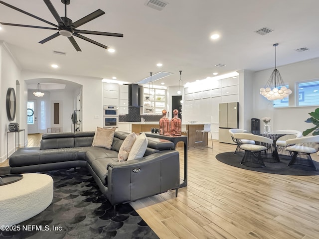 living room with ceiling fan and light hardwood / wood-style floors