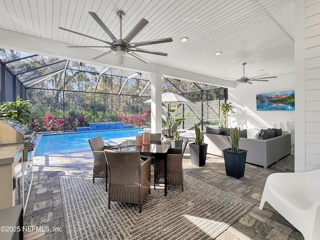 view of patio with an outdoor living space, a lanai, area for grilling, and ceiling fan