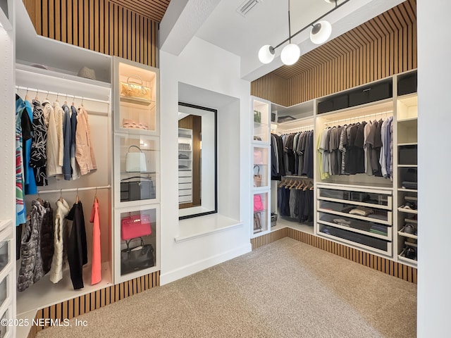 walk in closet featuring carpet flooring