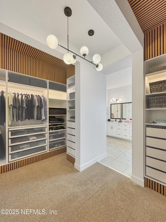 walk in closet featuring light colored carpet