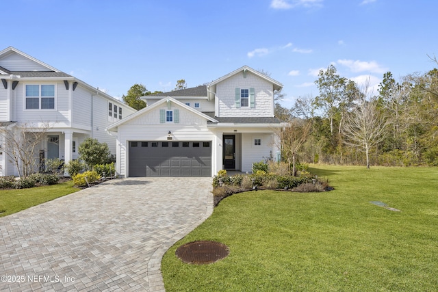 view of front of home with a garage and a front lawn