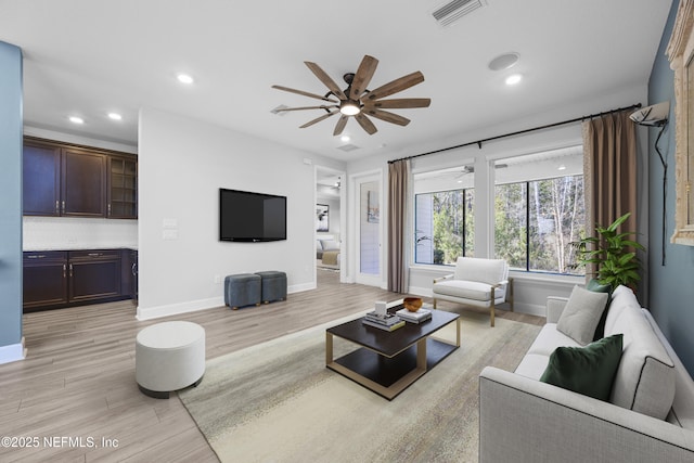 living room featuring ceiling fan and light wood-type flooring