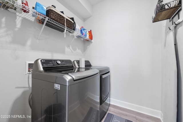 laundry area featuring hardwood / wood-style flooring and washer and clothes dryer