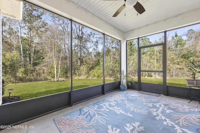 unfurnished sunroom with ceiling fan