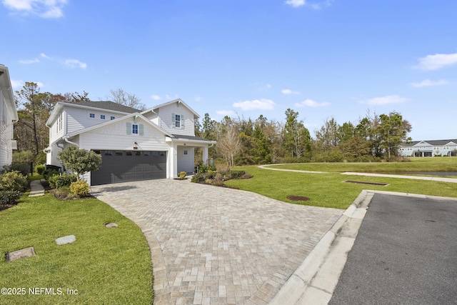 view of front of home featuring a garage and a front yard