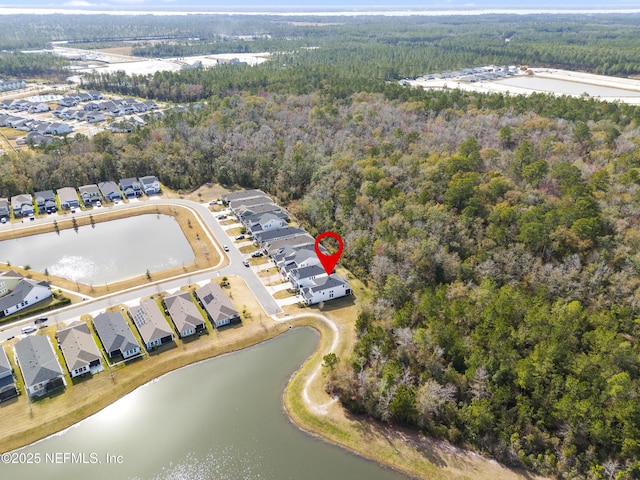 birds eye view of property with a water view