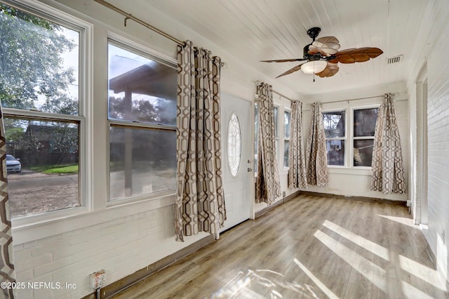 unfurnished sunroom featuring wooden ceiling and ceiling fan