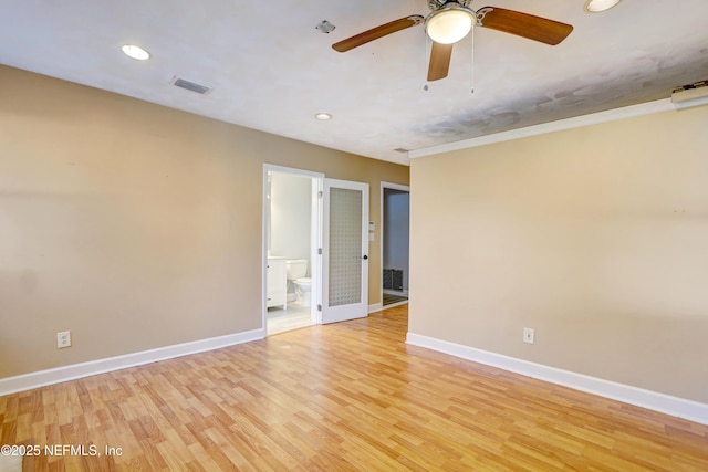 spare room featuring light hardwood / wood-style floors and ceiling fan