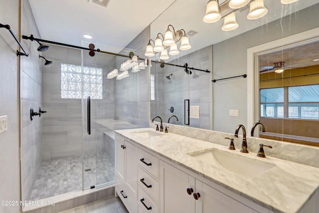 bathroom with vanity and a shower with shower door