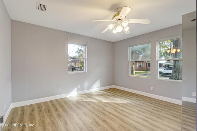 empty room featuring ceiling fan and light hardwood / wood-style flooring