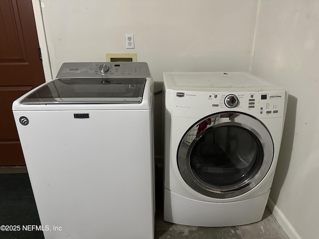 clothes washing area featuring washer and clothes dryer