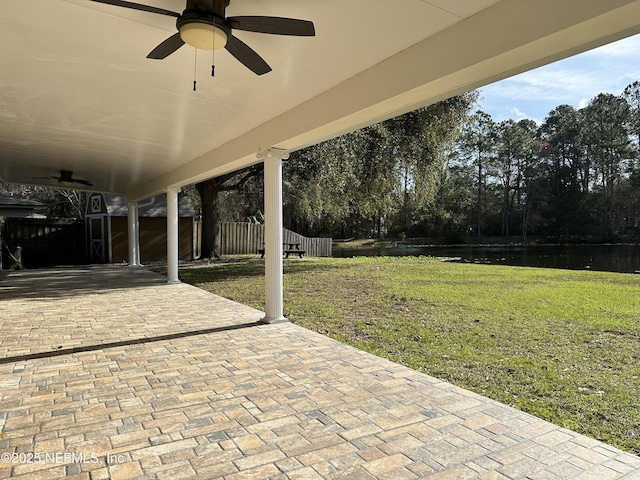 view of patio / terrace with a water view and ceiling fan