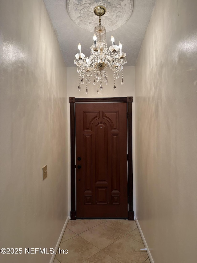 doorway to outside featuring light tile patterned floors and a chandelier