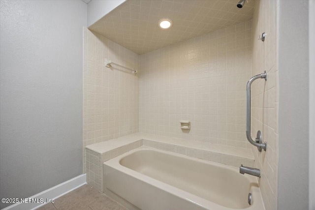 bathroom featuring tiled shower / bath and tile patterned floors