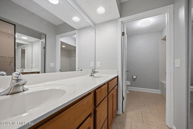 bathroom featuring vanity, toilet, and tile patterned flooring