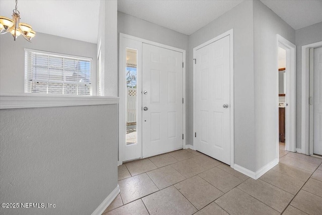 entryway featuring an inviting chandelier