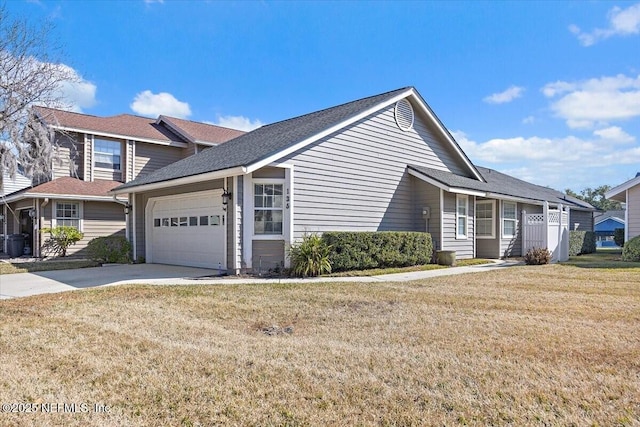 view of front of house with a garage and a front lawn